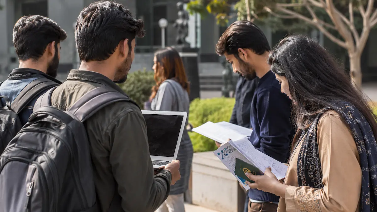 Pakistani graduate reviewing fully funded China scholarship documents