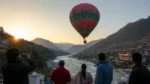 Tourists enjoying a hot air balloon ride over Pakistan's scenic mountain landscape